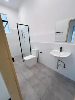 a white bathroom with a toilet and a sink at Canning 48 in Ipoh