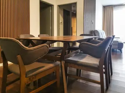 a dining room with a wooden table and chairs at Sunrise Serenity at Palas Horizon Residence in Brinchang