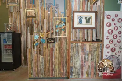 a room with a wall covered in books at Parlor Hotel in Ipoh