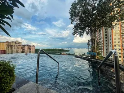 a swimming pool in the middle of a city at 3B2R 2CarPark Tea Time Suite with Infinity Pool in Jelutong