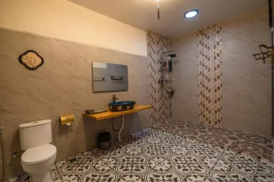 a bathroom with a bed and a toilet in a room at LINN House Peranakan Residence George Town in George Town