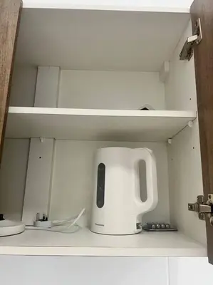 a white appliance sitting on top of a shelf at Lily Cameron-Tanah Rata in Tanah Rata