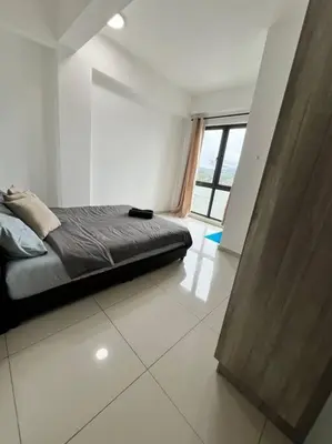 a bedroom with a bed and a large window at Lily Cameron-Tanah Rata in Tanah Rata