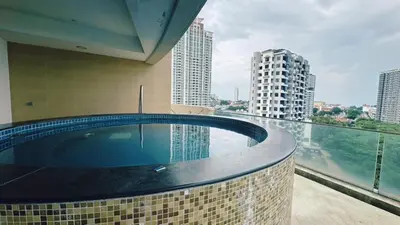 a swimming pool in a building with a view of a city at 118 Island Plaza ComFy Seaview Suite in Tanjong Tokong