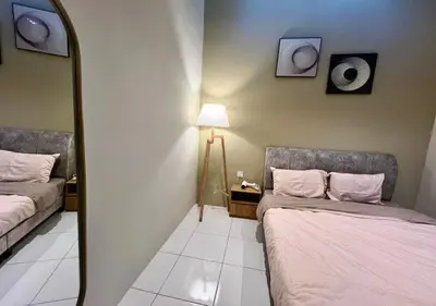 a room with two beds and a mirror at Polo Stay, 4 bedroom Single Storey house Ipoh for 10 pax in Ipoh