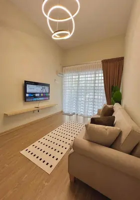 a living room with a couch and a flat screen tv at Polo Stay, 4 bedroom Single Storey house Ipoh for 10 pax in Ipoh