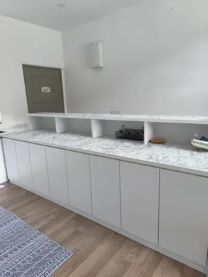 a white kitchen with a counter with a tv on it at #MyLuxeGetaway,Quintet Cameron Highlands in Cameron Highlands