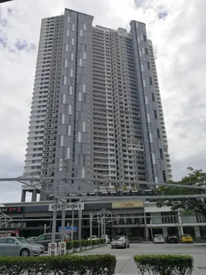 a large building with cars parked in front of it at LM HomeyC 3BR Family Suite for 4-14 Pax with Nexflix & Coway Water Purifier in Tanjong Tokong