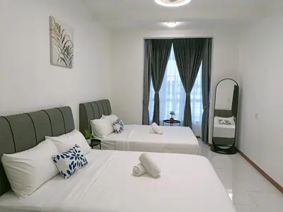 a hotel room with two beds and a mirror at Dream studio Emerald avenue in Cameron Highlands