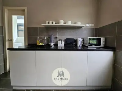 a kitchen with a counter top with a microwave at The Cove Hillside Residence - Grandiose Oasis in Ipoh