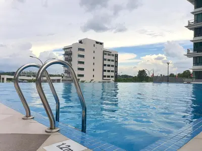 a swimming pool with a building in the background at Ipoh Meru Casa Kayangan 6 Pax Fully Air-Con Homestay in Ipoh