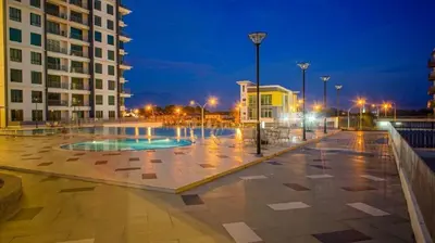 a courtyard in a city at night with buildings at Ipoh Meru Casa Kayangan 6 Pax Fully Air-Con Homestay in Ipoh