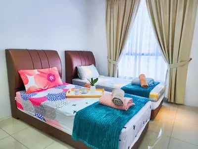 a bedroom with two beds with hats and towels at Ipoh Meru Casa Kayangan 6 Pax Fully Air-Con Homestay in Ipoh