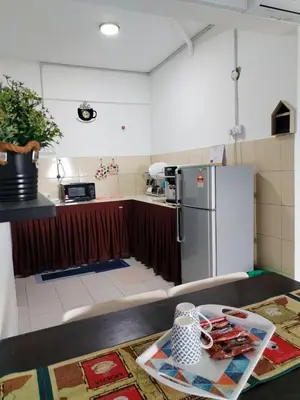 a kitchen with a counter top with a refrigerator at MyPutra Homestay Parit Buntar in Parit Buntar