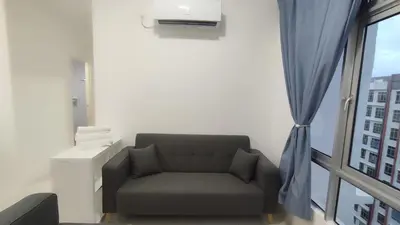 a living room with a couch and a window at Sweet Home Ipoh in Ipoh