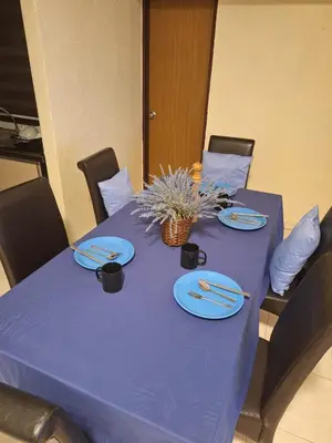 a purple table with plates and utensils on it at Seaput Homes in Ayer Itam