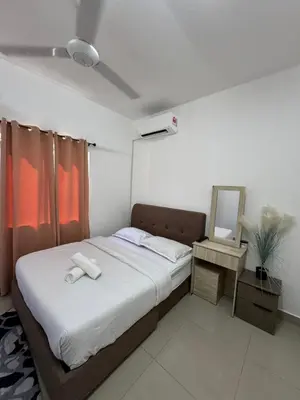 a bedroom with a bed with two towels on it at FHS Homestay Trong Taiping in Bukit Gantang