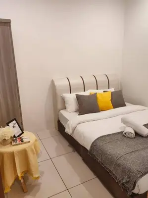 a bed with pillows and a table in a room at NEW! Spacious 3BR Luxury Stay at Sunrise Gurney GeorgeTown in George Town