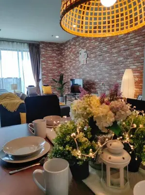 a dining room table with plates and flowers on it at NEW! Spacious 3BR Luxury Stay at Sunrise Gurney GeorgeTown in George Town