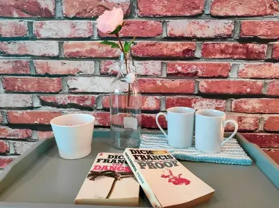a table with two cups and a vase with a rose at NEW! Spacious 3BR Luxury Stay at Sunrise Gurney GeorgeTown in George Town