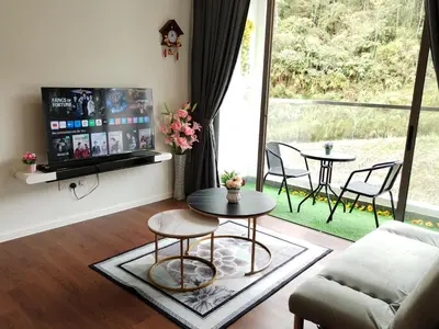 a living room with a table and a large window at Palas Horizon Home B-7-11 in Brinchang