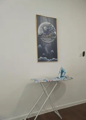 a table in front of a wall with a painting at Palas Horizon Home B-7-11 in Brinchang