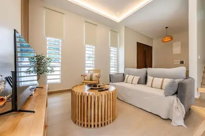 a living room with a couch and a table at La Ferringhi Villa by BRB in Batu Ferringhi