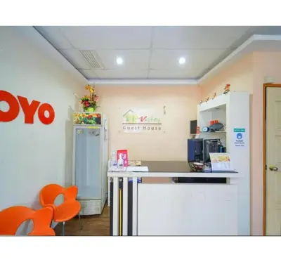 a kitchen with a counter and a refrigerator at Hotel O J Stay Guesthouse in Jelutong