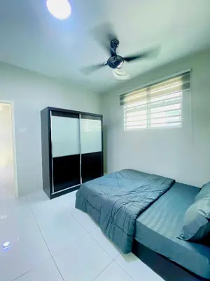 a bedroom with a bed and a ceiling fan at D'villa Aryan homestay with private pool in Sungai Petani