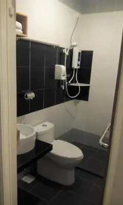 a bathroom with a toilet and a sink at JQ Suria 18 Hotel in Ipoh