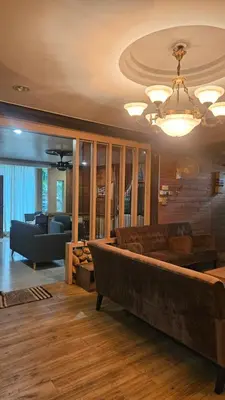 a living room with a couch and a chandelier at Mount Lake Villa in Ipoh