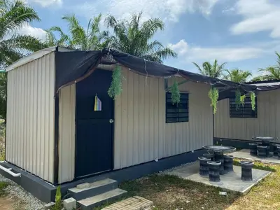 a building with a black cover over the door at YN cabin in Tanjung Karang