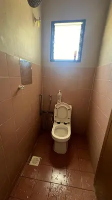 a small bathroom with a toilet with a window at Atbas Homestay No 1 in Seri Iskandar
