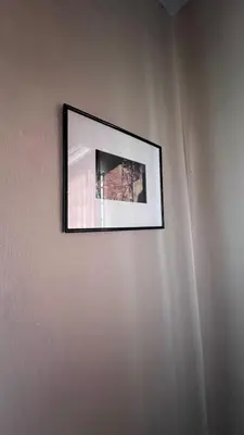 a picture hanging on a wall in a room at Atbas Homestay No 1 in Seri Iskandar