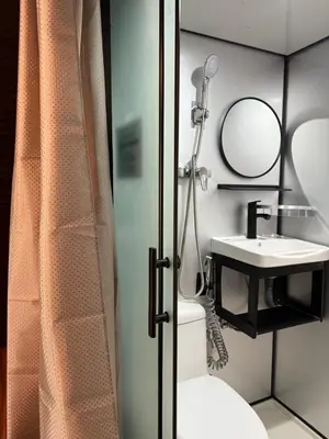 a bathroom with a sink and a toilet and a mirror at Chalet Kuala Woh Resort in Tapah