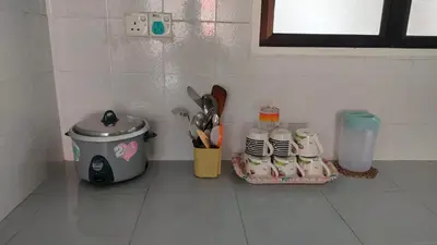 a kitchen counter with a toaster and some kitchen items at Desa Anthurium Apartment in Tanah Rata