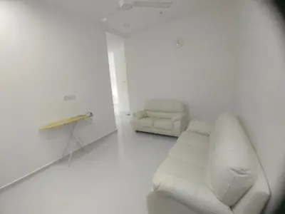 a white living room with a couch and a chair at Homestay Bajet Cikgu Amin in Bagan Serai