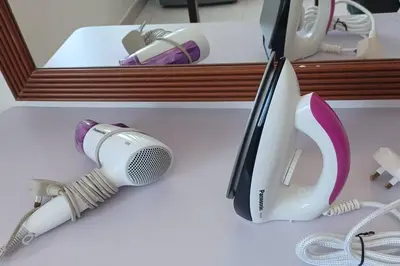 a hairdryer and a hair dryer on a counter at Pepper Hillside Village Home in Tanjung Bungah