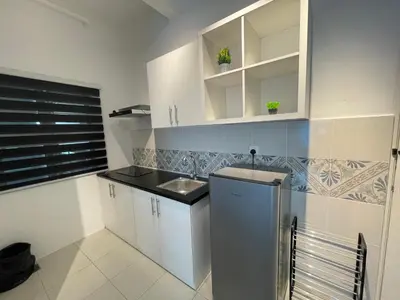 a small kitchen with white cabinets and a sink at Ipoh Town The Anderson Residence in Ipoh