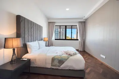 a bedroom with a large bed and a window at The Landmark Seaview Suite in Tanjong Tokong
