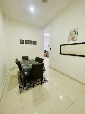 a room with a table and chairs and a wall at D Alamanda Islam Homestay in Kuala Kangsar