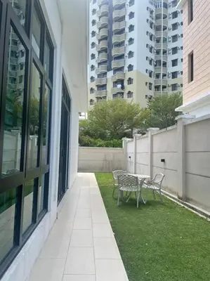 a patio with a table and chairs next to a building at Batu Ferringhi Home Near Beach in Penang in Batu Ferringhi