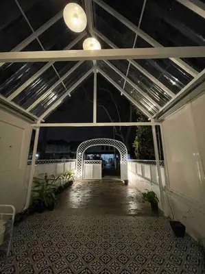 a hallway of a building with a ceiling and a walkway at Modern Victorian Homestay in George Town