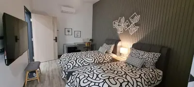 a bedroom with a bed and a chair in it at Suites Only KKB in Kuala Kubu Baharu