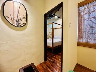 a mirror on the wall of a room with a bedroom at New Takekaze Retreat \u7af9\u98ce\u4e4b\u5bb6 for 14 pax at Central Penang in George Town