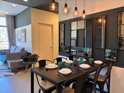 a dining room and living room with a table and chairs at Cameron Golden Hills Near Night Market CH1 in Brinchang