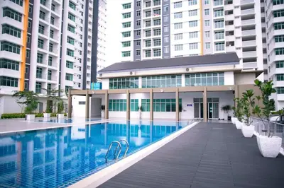 a swimming pool in a building with tall buildings at Residensi Meru Raya in Ipoh