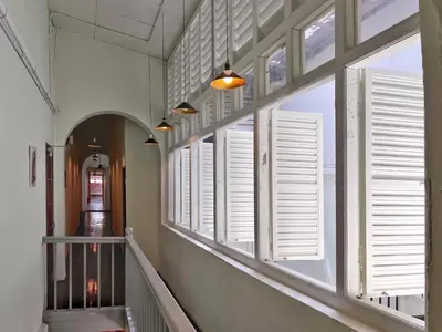 a hallway with white windows and a staircase at Pine Muntri in George Town