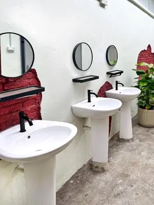 a bathroom with two sinks and mirrors on the wall at Pine Muntri in George Town