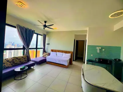 a bedroom with a bed and a couch in a room at cozy 3BR family suites 10pax in Jelutong